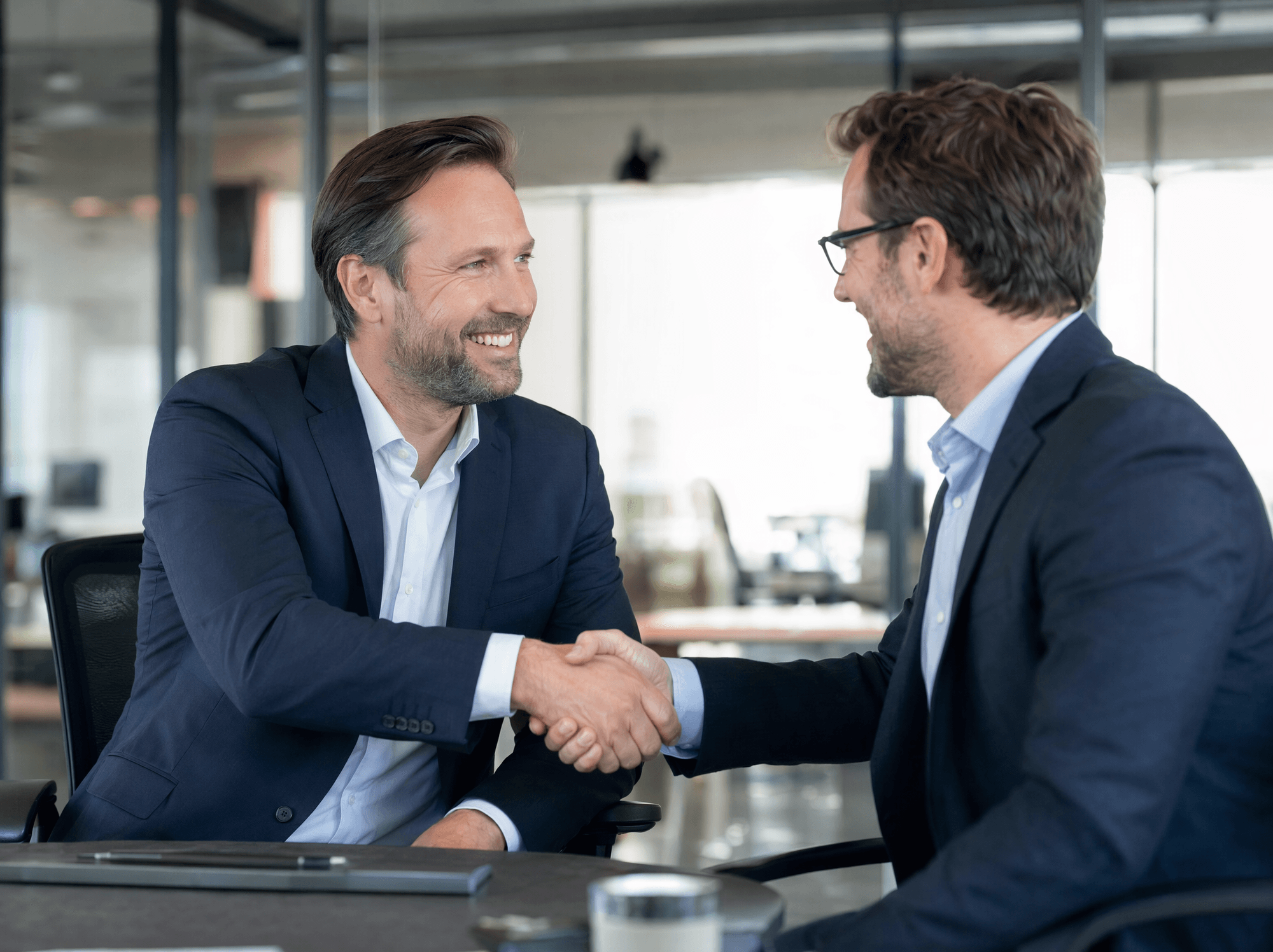 Editorial photo: a Western sales rep shaking hands with a buyer in an office