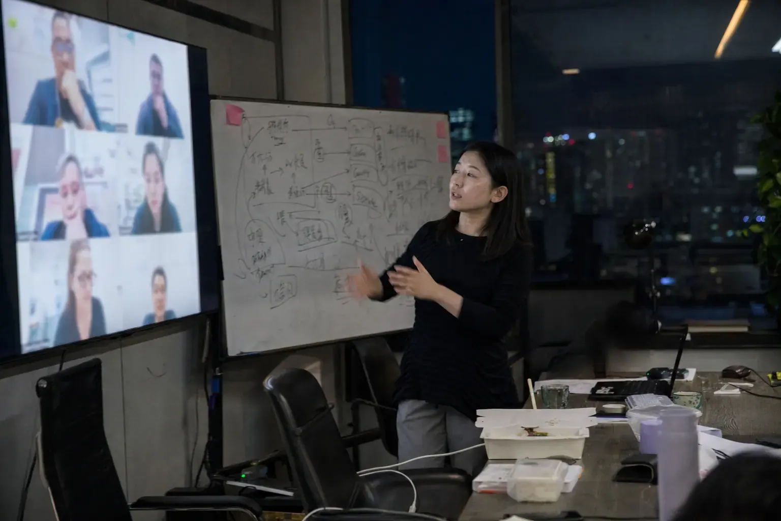 A Chinese channel manager in Guangzhou running an evening video call with overseas distributor partners