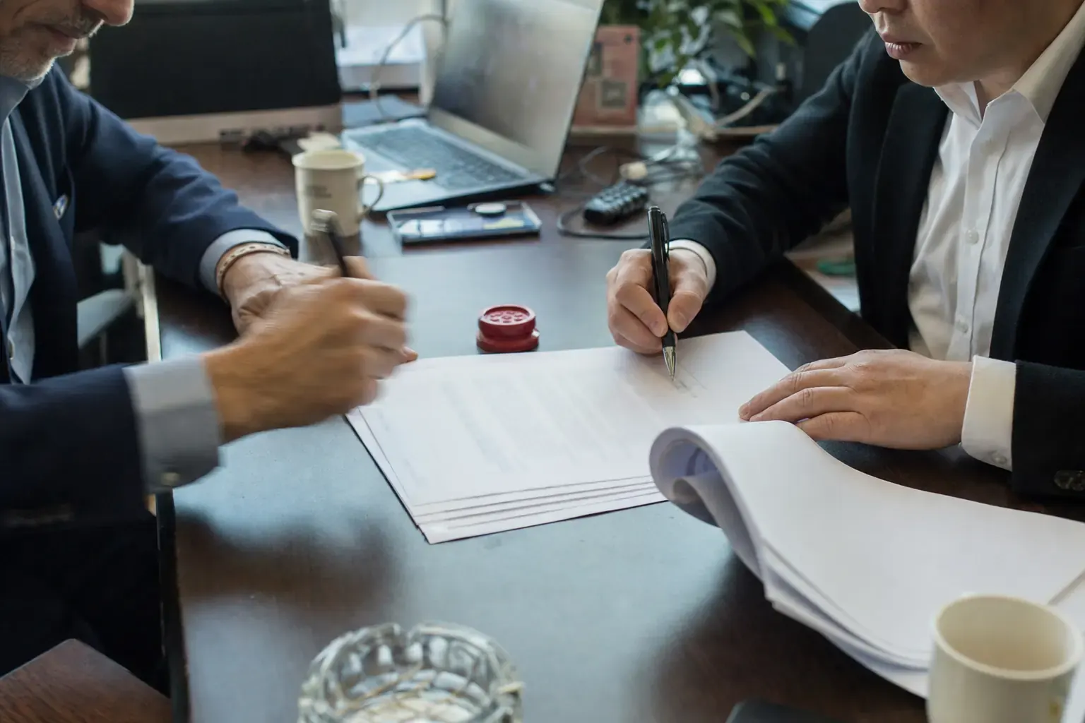 A Chinese company chop beside a distribution agreement being signed with a European distributor